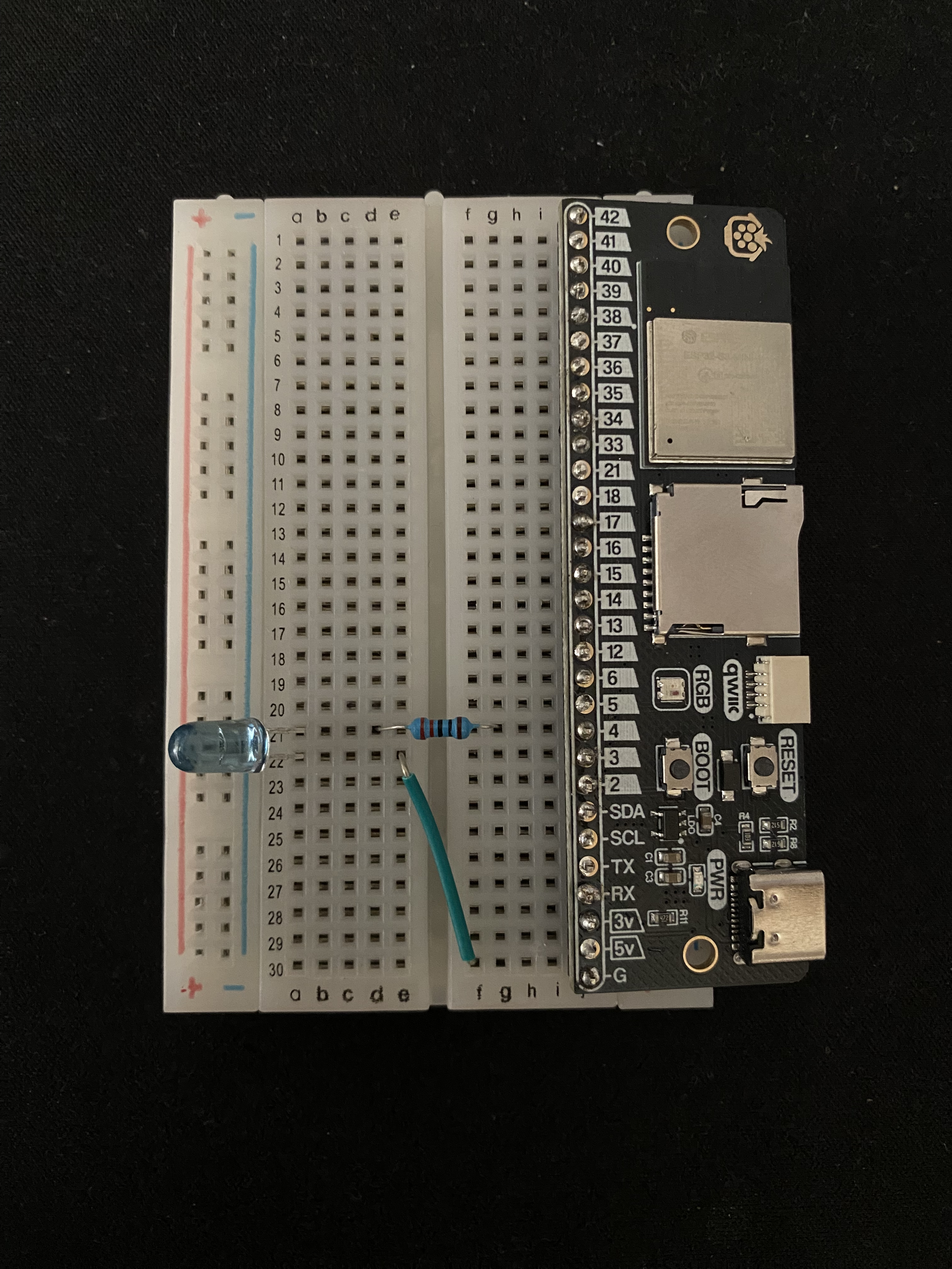 Breadboard showing connected pins, 220 ohm resistor, IR LED and connecting wire